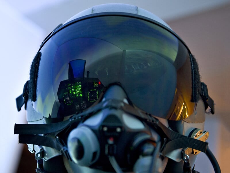 Gros plan sur le casque de pilote de F-35 avec des reflets montrant les écrans du cockpit et les informations de vol