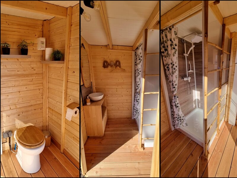Intérieur d'une salle de bain en bois avec toilettes, lavabo, douche lors d'un séjour insolite dans la Baie de Somme.