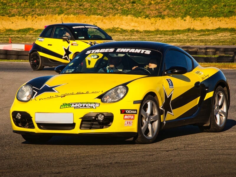 Voiture de course jaune et noire avec des étoiles noires, inscrite 