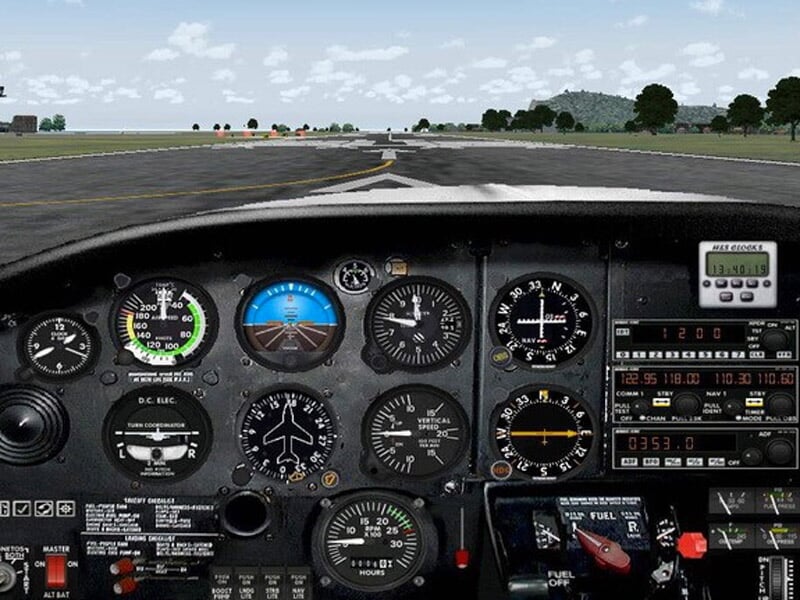 Tableau de bord d'un avion avec plusieurs instruments de vol visibles, prêt pour le décollage sur une piste.