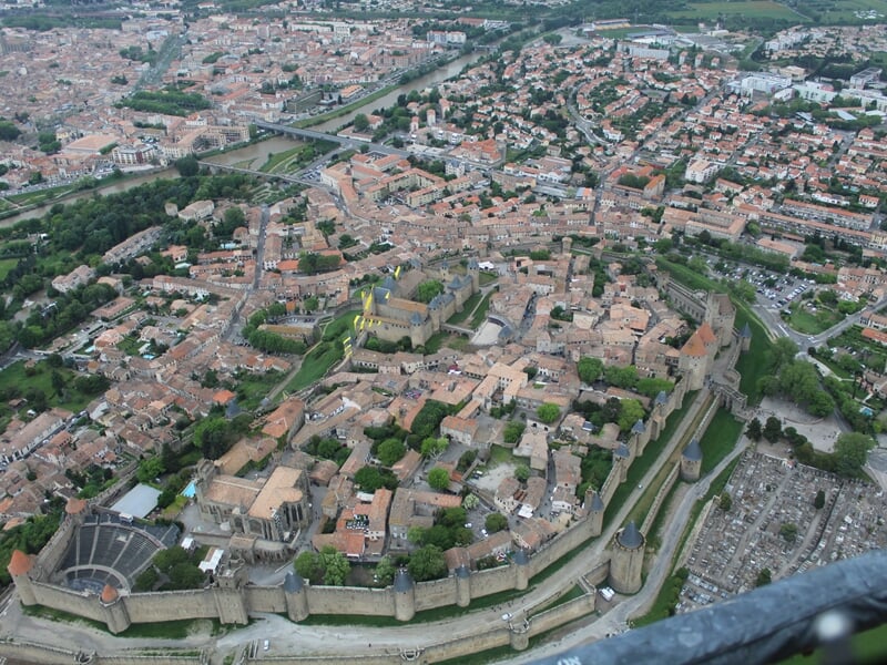 Plan rapproché d'une cité médiévale fortifiée vue du ciel avec ses rues et bâtiments anciens.