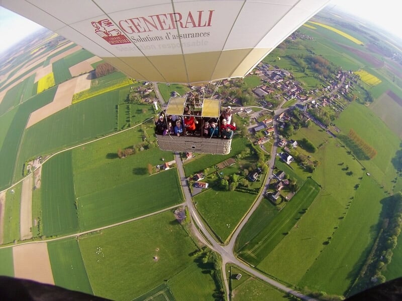Vue depuis la nacelle d'une montgolfière montrant le brûleur et la toile colorée au-dessus.