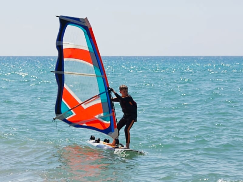 enfant sur une planche à voile