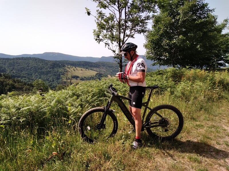Homme à vtt électrique sur point en hauteur avec vue dégagée