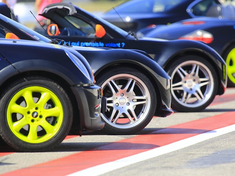 Des voitures de sports garées sur le parking des stands du circuit Paul Ricard dans le Sud de la France
