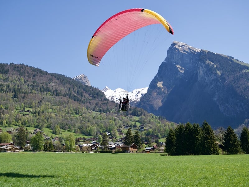 Personne s'apprêtant à se poser en parapente