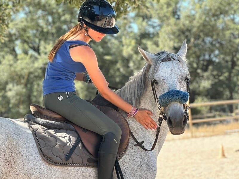 Jeune femme qui monte un cheval