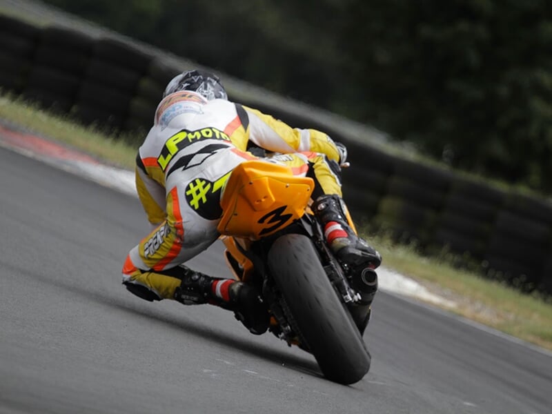 Un pilote de moto amorce un virage sur un circuit de vitesse lors d'une journée de roulage libre