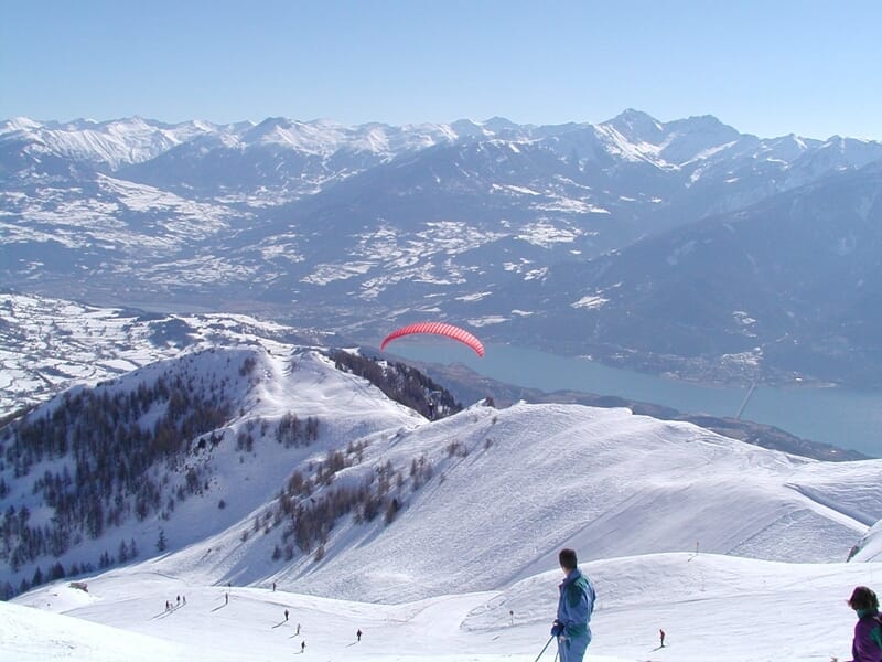 Parapente au dessus des montagnes enneigées