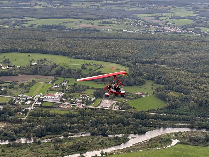 Un ULM pendulaire survole la région d'Epinal lors d'un vol d'initiation au pilotage ou un baptême de l'air