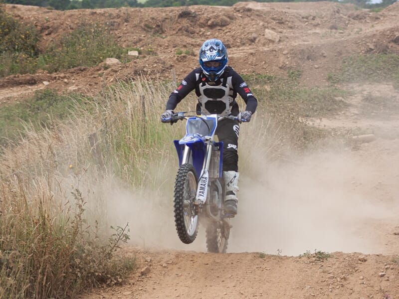 Adulte franchissant une bosse en motocross