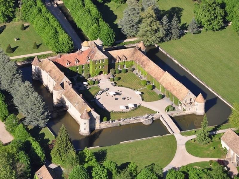 Vu aérienne sur un château entouré de douves, de forme carrée